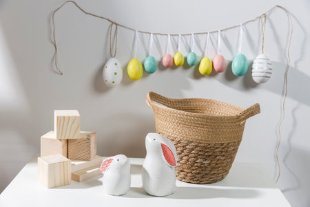 Fragment of the interior. Decorated children's room for Easter. A garland of plastic eggs on the...