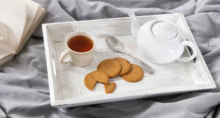 interior and home coziness concept. Top view. A cup of tea, a teapot with herbal tea, sugar bowl on...