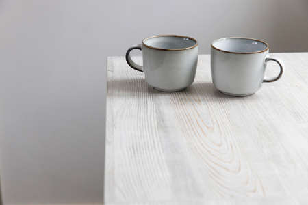 Two porcelain light blue cups are on the tableの写真素材