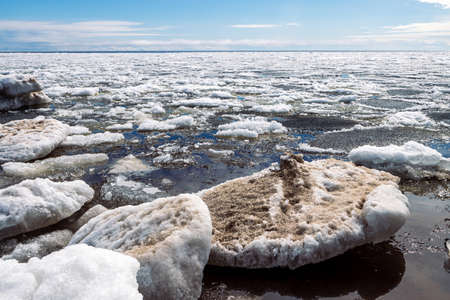 Lake Ladoga covered with ice in front of the icebreaker. The sky with light cirrus clouds is...