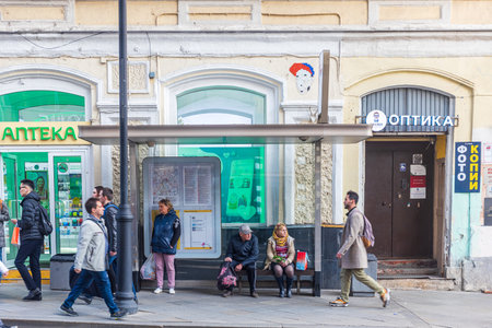 Moscow, Russia - 22 May 2022, People sit on a bench at the bus stop at Maroseyka while waiting for the busのeditorial素材