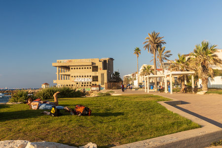 Haifa, Israel - June 20, 2022, Bat Galim beach at sunset, palm trees, sea, sandstone stepsのeditorial素材
