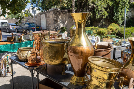 Haifa, Israel - 20 July 2022, Scene of the flea market, with sellers and shoppers, in downtown. Various copper jugsのeditorial素材