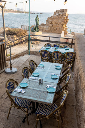 CAESAREA, Israel - August 11 2022, Hellena Restaurant Caesarea Harbor, tables and sea viewのeditorial素材