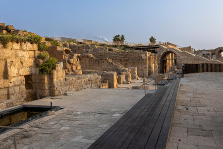 CAESAREA, Israel - August 2022, Roman emperor statue reflecting in a pool, Numerous tourists visit ruins fortress built by Herod the Great near Caesarea city, on the shores of the Mediterranean Seaのeditorial素材