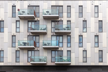 fragment of a facade of a building with balcony with table and chairの写真素材