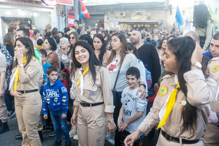 Haifa, Israel - December 17, 2022 : Pupils of St. Elias Episcopal school participate in the Christmas parade in the German Colony. Spectators watch the paradeのeditorial素材