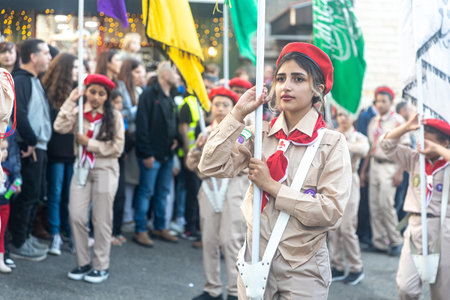 Haifa, Israel - December 17, 2022 : Pupils of St. Elias Episcopal school participate in the Christmas parade in the German Colony. Spectators watch the paradeのeditorial素材