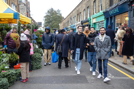 London, Uk - 17 December 2022, Columbia Road Flower Market is a street market. Men go to the marketのeditorial素材