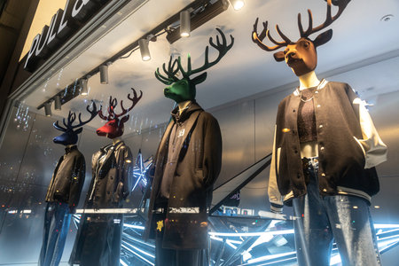 London, Uk - 17 December 2022, Mannequins with multi-colored deer heads in modern black bombers and jackets.のeditorial素材