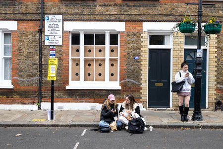 London, Uk - 17 December 2022, People eat street food while sitting on the curb. Brick Lane area.