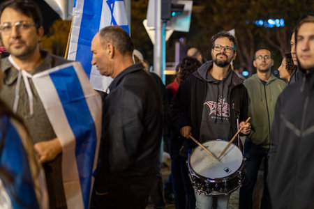 Haifa, Israel - January 21, 2023: People protest with signs against the legislative plans of the new government. A man protest with a drumのeditorial素材
