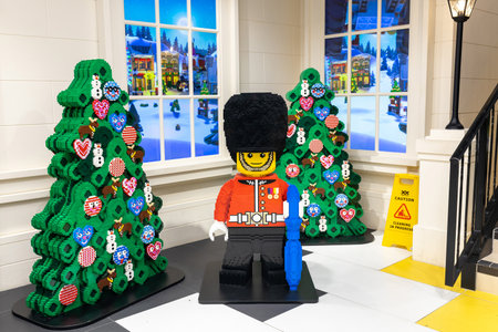 London, UK - 10 December 2022, Christmas trees and an English guard in a traditional hat built from...