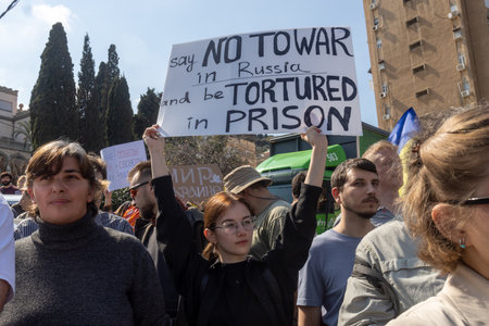 Haifa, Israel - February 24, 2023, the anniversary of the start of war between Russia and Ukraine. Rally near Russian consulate. Girl with poster - say no to war in Russia and be tortured in prison.のeditorial素材