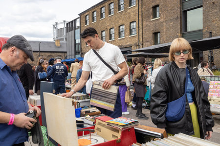 London UK - April 15 2023: Classic Car Boot Sale by Vintage. Retro festival. People selling vintage clothing, goods jewellery, homeware on their classic vehicles. Fifties style.のeditorial素材