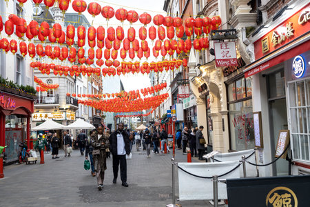 London,UK -18 April 2023, China Town is decorated by Chinese lanterns and lots of tourists and Londoners walking on the street. ChinaTown was established in 1880 by Chinese sailors and tradersのeditorial素材