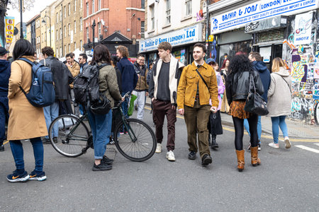 London, UK - 20 April 2023, A motley crowd is walking along Brick Lane.のeditorial素材