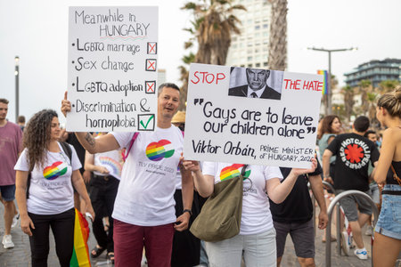 Tel-Aviv, Israel - June 08, 2023: View of various participants, in the annual Pride Parade of the LGBTQ+ community, A man holds a poster - Meanwhile, gay marriage is prohibited in Hungaryのeditorial素材