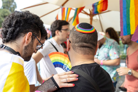 Haifa, Israel - June 24, 2023: People with protest signs in preparation to the annual LGBTQ pride parade. A man in a rainbow kippahのeditorial素材
