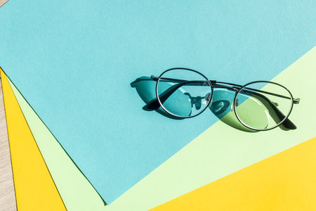 Business black glasses on blue background. Fashion office glasses reading in summer concept for promo banner sale and shoppingの写真素材
