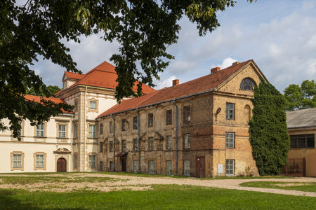 Vilnius, Lithuania - August 23, 2023, old house in Vilnius, entwined with wild grapes with a lawn in front of itのeditorial素材