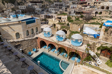 Cappadocia, Turkey -24 April 2024,  View from the restaurant to the pool and the town of Ortahisar with the foreground and the valley of Cappadocia in the background near the town of Goreme,のeditorial素材
