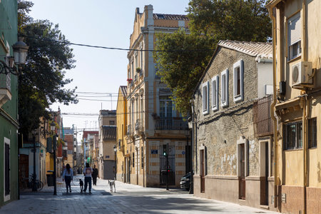 Valencia, Spain - 24 March 2024: Old multi-colored houses in the Cabanyal district, considered disadvantaged. Street Carrer de Carles Rosのeditorial素材