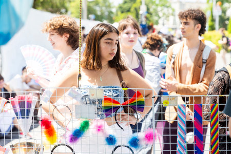 Haifa, Israel June 21, 2024, Pride Parade. A girl chooses a purchase at a kiosk with rainbow symbols.のeditorial素材
