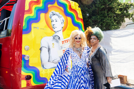 Haifa, Israel June 21, 2024, Pride Parade. Two drag queens pose for a photo in front of a Pride bus. One of them is wearing a dress in the colors of the Israeli flag.のeditorial素材