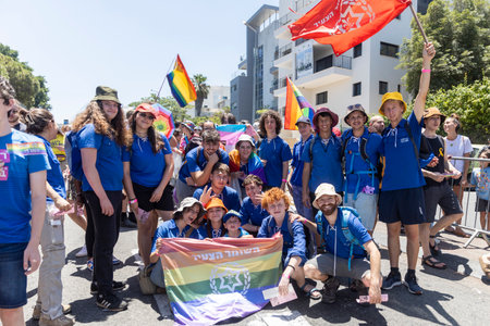 Haifa, Israel June 21, 2024, Pride parade. A group of young people in blue t-shirt take a photo with the flag of their organization.のeditorial素材