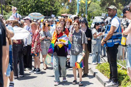 Haifa, Israel June 21, 2024, Pride parade. People with makeup and rainbow flags in the crowd.のeditorial素材