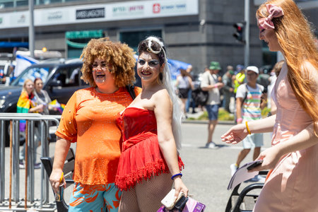 Haifa, Israel June 21, 2024, Pride parade. People with makeup and rainbow flags in the crowd.のeditorial素材