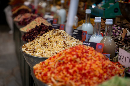 Sales of candied fruits for tea at the market - mangoes, lemons, ginger. Piled high in bowls.の写真素材