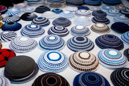 Kippahs in the colors of the Israeli flag for sale on a table at the market.の写真素材