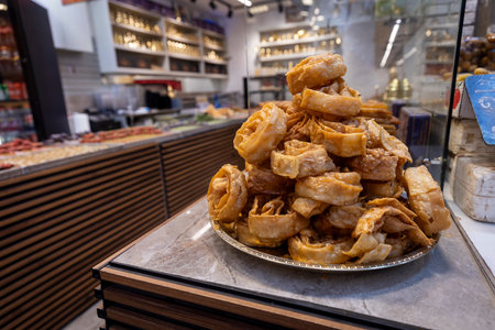 Honey baklava piled high on the counter in the Eastern sweets section.の写真素材
