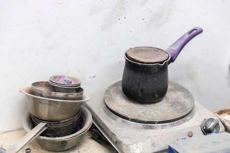 Melting wax or metal in a cezve on an electric stove in a workshop.の写真素材