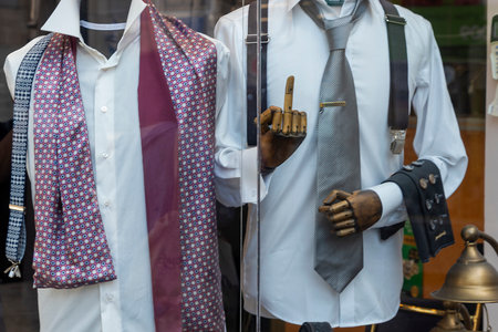 Jerusalem, Israel, 23 September 2025,  Stylish male mannequins in a store window display classic formal wear with shirts, ties, and accessories.の写真素材