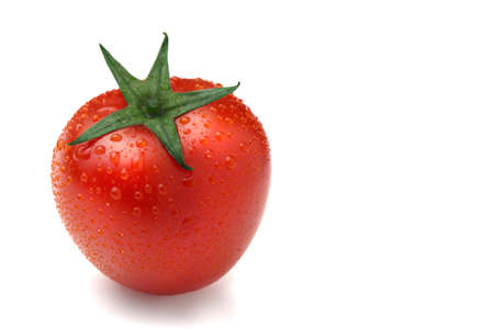 Close-up of a ripe red tomato isolated on white backgroundの写真素材