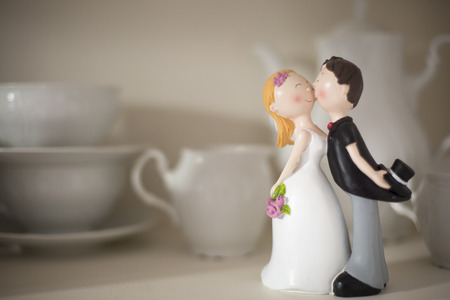 Close up of the statuette of spouses Placed in the middle of a tea service wedding giftの写真素材