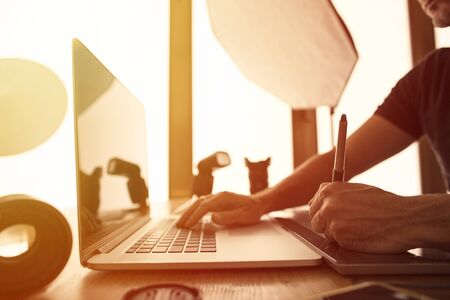 Portrait of a photographer working on pc in his studio