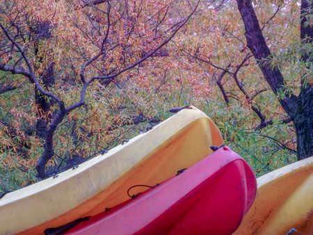 Red and yellow kayaks stacked up on a beautiful cool autumn day in Central Park,Manhattan