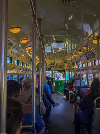 commuters sit peacefully enjoying a ride on the F Tram along Fisherman's Wharf in San Franciscoのeditorial素材