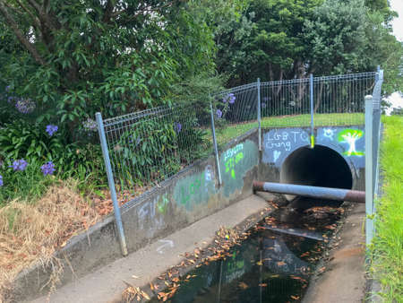 Thursday Feb 7th 2019, Auckland New Zealand - The entrance to a sewage gutter duct is marked with LGBTQ graffitiのeditorial素材