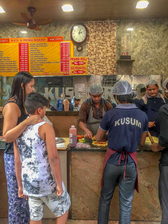 Kolkata India, Thursday Jan 11th 2018 - a woman and boy look on as their order of mutton kathi rolls...