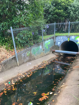 Thursday Feb 7th 2019, Auckland New Zealand - The entrance to a sewage gutter duct is marked with LGBTQ graffitiのeditorial素材