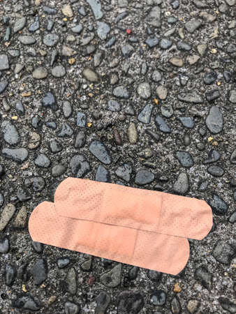 Overhead perspective of wound seal plaster on gravel backgroundの写真素材