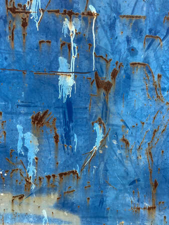 Rusty oxidation of a blue painted metal surface creating an artistic abstract imageの写真素材
