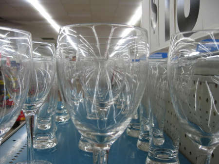 Rows of wine glasses under interior lightsの写真素材