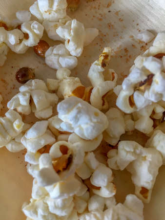 Popcorn strewn on a table top overhead viewの写真素材