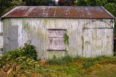 Old abandoned rusty shed closed and boarded upの写真素材